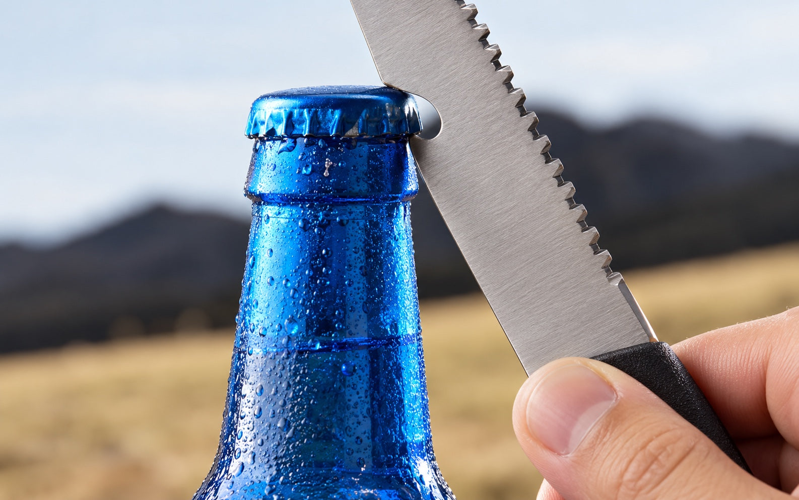 The bottle-opening notch on the removable blade lifting a bottle cap