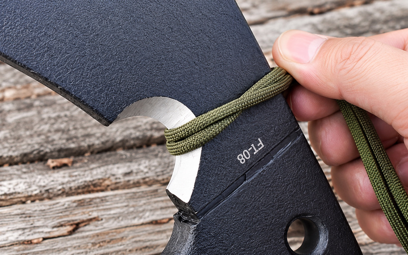 Cord held across the recessed cutting notch beneath the axe head